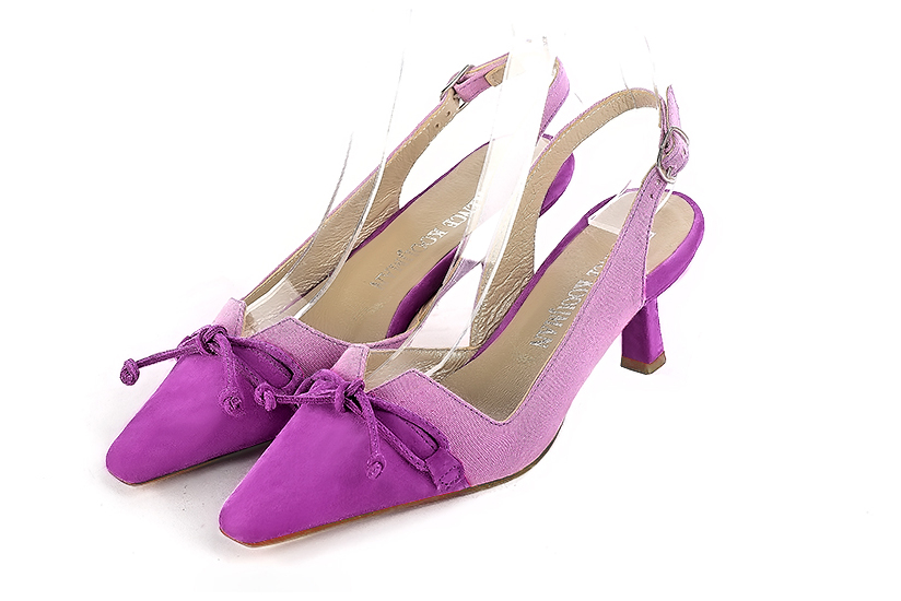 Mauve purple open back shoes with a knot. Tapered toe. Medium spool heels